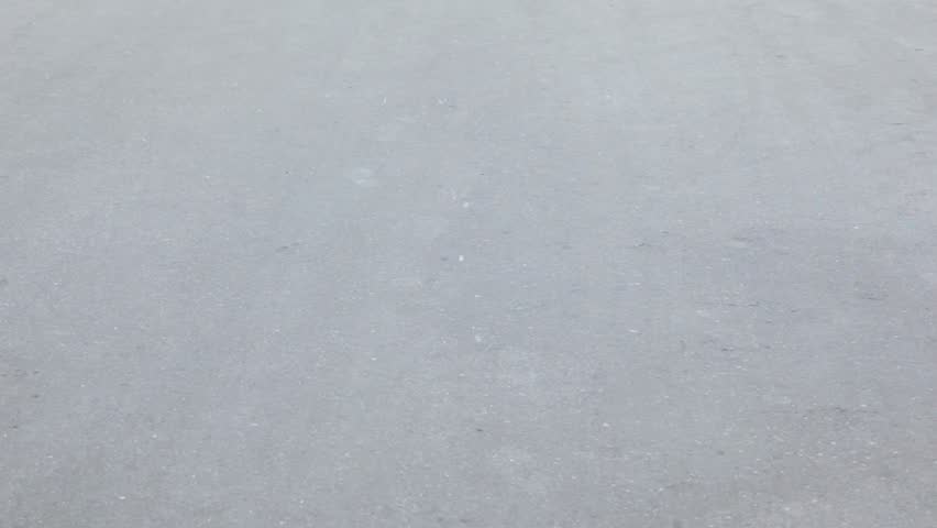 Little boy in red shirt and jeans ride on scooter by asphalt, view from behind