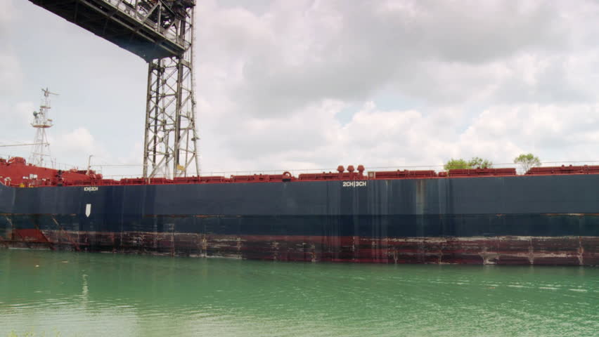 Ship moving slowly under Vertical Lift Bridge along the Welland Canal toward Lake Ontario, Welland, Ontario, Canada.