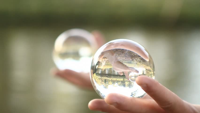 Man doing contact juggling on palms and crystal balls