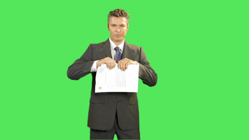 Business male tearing up contract on greenscreen
