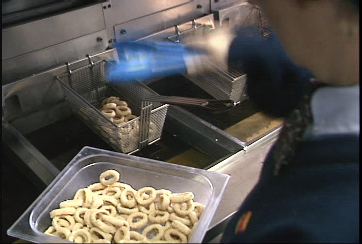 Deep frying onion rings - 2 shot (clip 2 of 4)