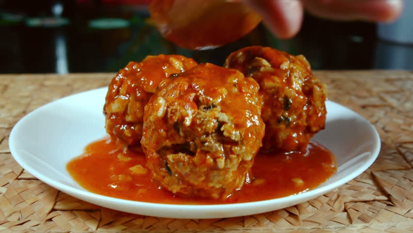 Serving Meatballs Sequence (HD). Beef Meatballs with onion, egg, peppermint and rice being served on a dish crowned with mint leaves made up of several shots in a sequence.