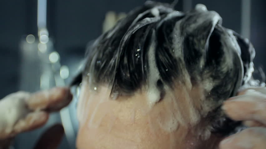 Man washes his hair