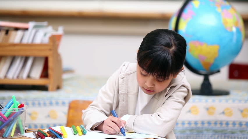 Pupils playing with a magnifying glass in the classroom