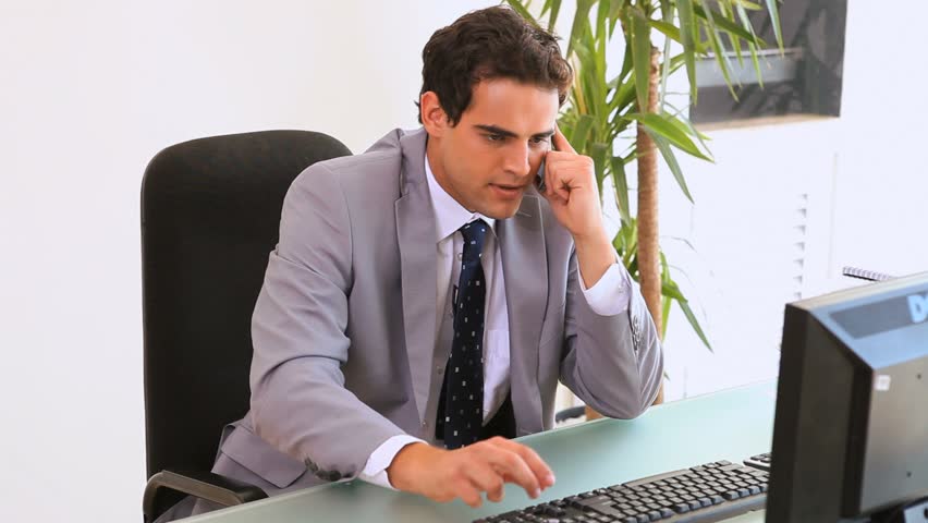 Annoying businessman hanging up the phone in his office