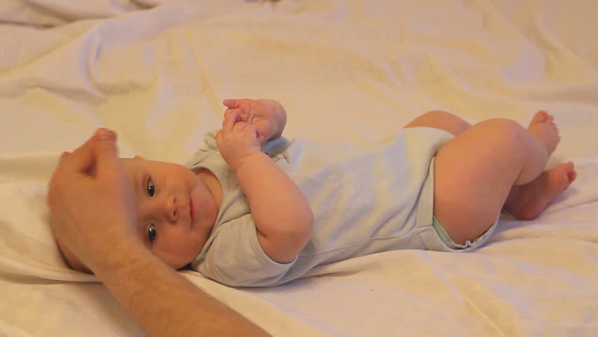 Father's hand caressing cute baby