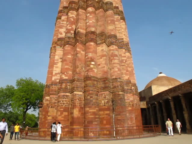 DELHI - APRIL 17: An airplane flying past Qutb Minar, a UNESCO World Heritage Site, on April 17, 2012 in Delhi, India. Qutub minar is the world's tallest minaret with a height of 72.5 m.