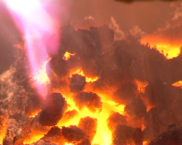 closeup of burn straw granules in boiler. flames and fire detail. ecologic fuel use for house heating.