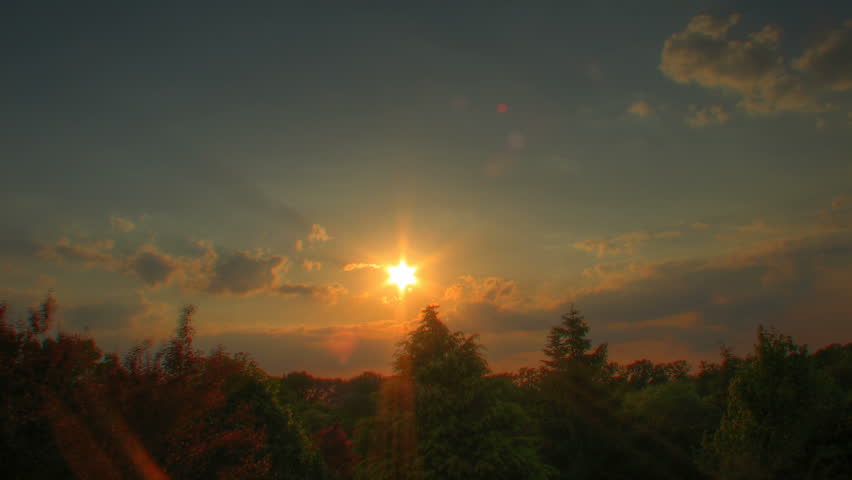 Sunset time lapse over trees, high dynamic range imaging