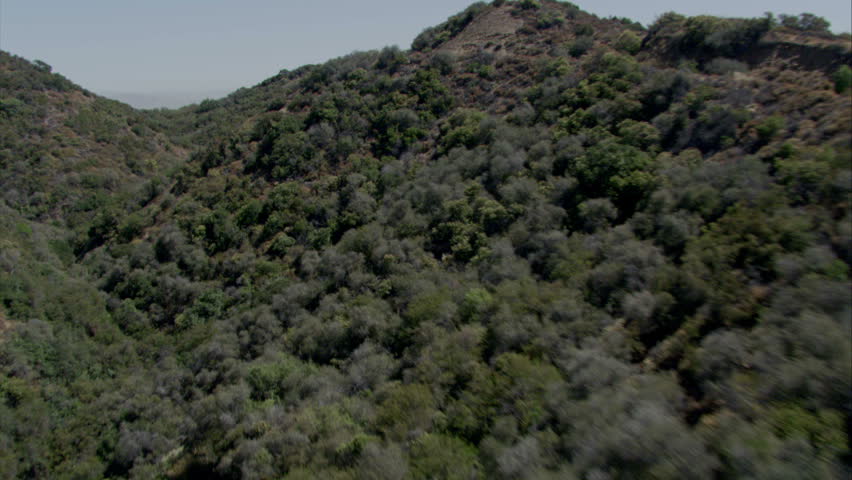 Aerial view flying up a rugged canyon