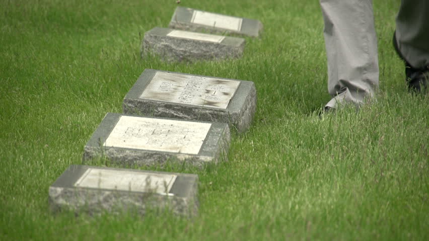 US flags being placed in front of graves