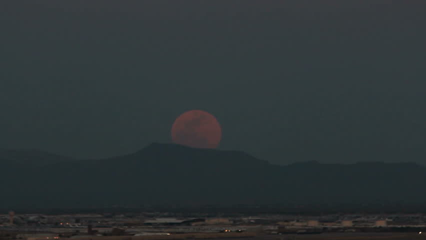 Moonrise over city lights. 1080p