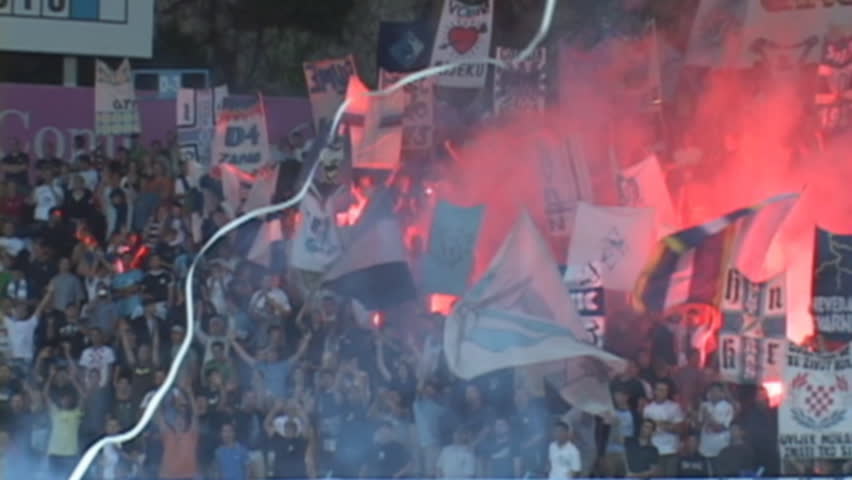 soccer or football fans with torches