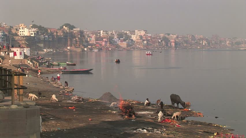 Ganges river and funeral Pyre burning.Circa, Veranasi, India