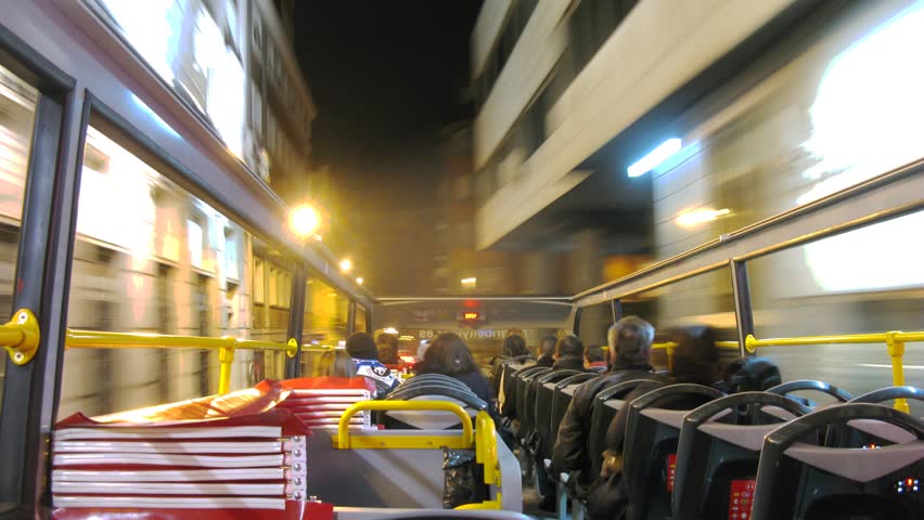 MADRID - MAR 10: (Timelapse View) Passengers go in open bus at night, on Mar 10, 2012 in Madrid, Spain