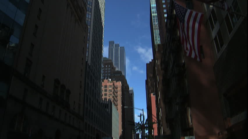 Quiet NYC street scene tilt up and pan looking up through buildings, New York, NY