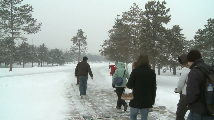 tourists walking on snow covered sidewalk into Terra Cotta warrior museum, Xian, China