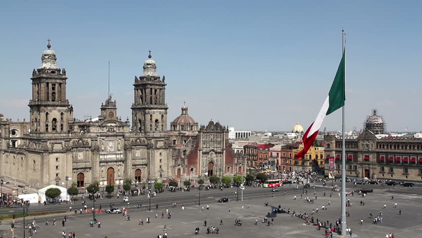 the zocalo in mexico city, with the cathedral and giant flag in the centre