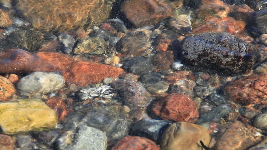 Close up of waves crashing on stony Beach Shore on the german Baltic Sea