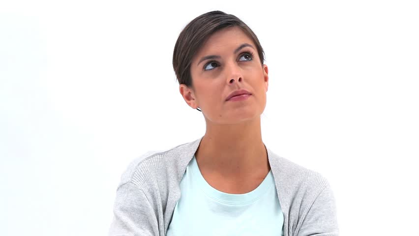 Thoughtful woman looking up against white background