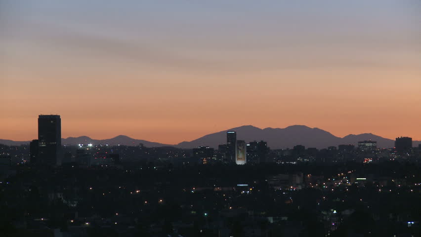 Downtown Los Angeles skyline at sunrise with heat haze and mountains in the background