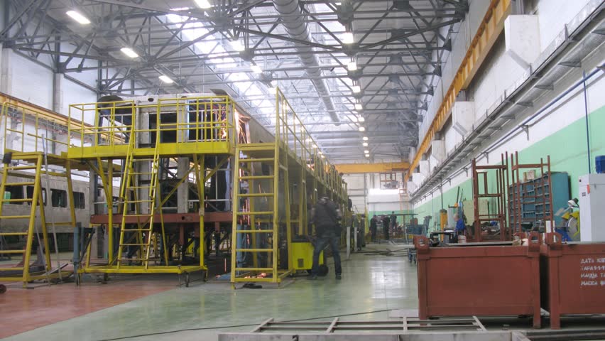 MYTISCHI - APR 18: (Timelapse View) Workers go on iron ladders near new carriage at plant Metrowagonmash, on April 18, 2012 in Mytischi, Russia