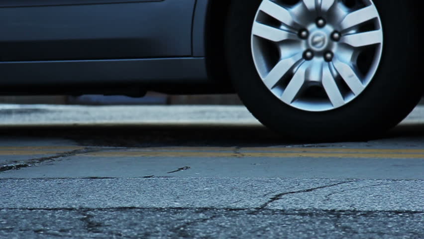 Slow motion shot of steam coming from a manhole in a street.
