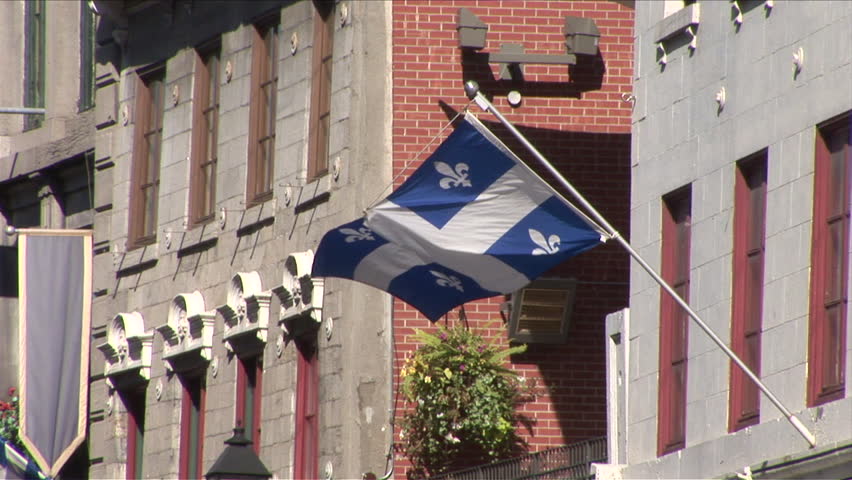 View of Quebec Flag flapping in the wind in Montreal Canada