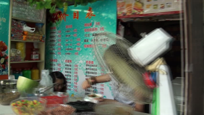 CHONGQING - AUGUST 17: Walking past small shops on August 17, 2010 in Chongqing, China