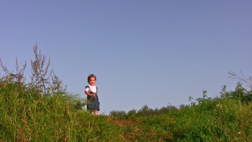 little girl walking on meadow alone 