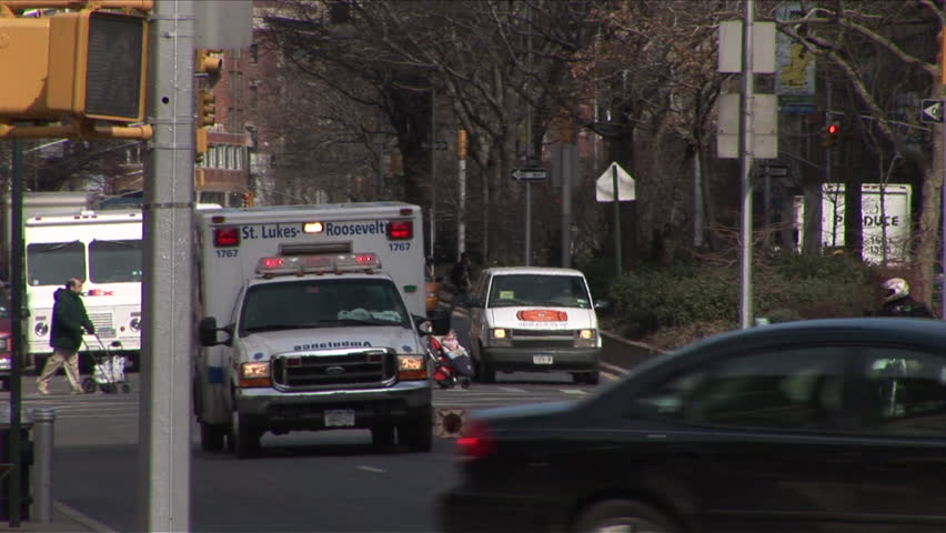 New York, NY - CICRA March 2006: An ambulance rushes down the street in Manhattan. The wail of the siren is a staple of NYC life  and many New Yorkers have learned to tune out the annoyance
