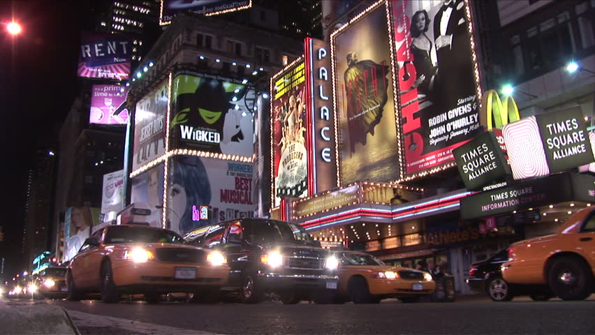 New York, NY - CIRCA March 2006: Many cars and buses drive through Times Square at night as the billboards light there way 