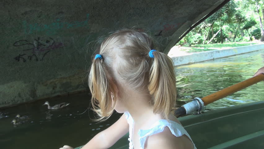 Child on a Boat, Little Girl Boating watching Mother Duck and her Ducklings  
