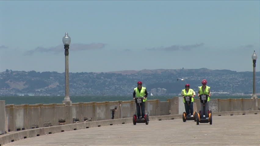 San Francisco, CA - CIRCA May, 2006: A pack of tourists tour the bay on Segway scooters and look ridiculous