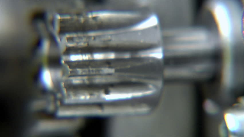 Close-up of rotating cogs with depth of field. Camera footage, NO CGI!

