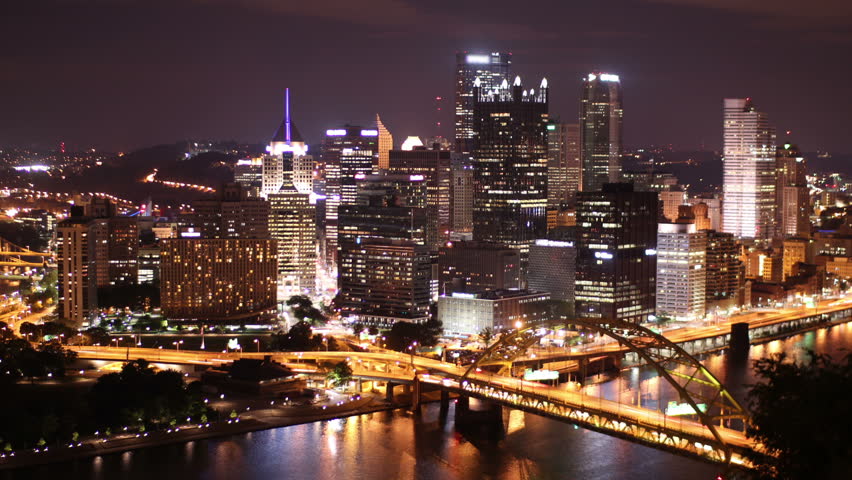 Dramatic nighttime time lapse shot of Pittsburgh, PA.  As seen from Mount Washington.  Corporate logos digitally obfuscated for general usage.  Available in 4K upon request.