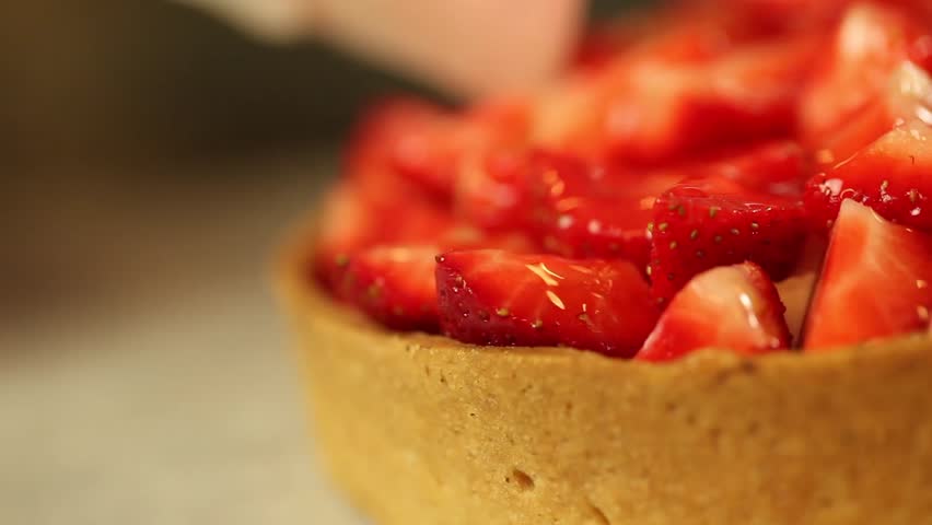 putting sugar gelatin on strawberry  tart pan left