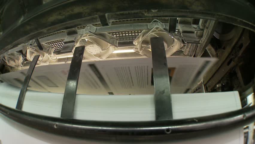 Printed sheets coming out of commercial printing press