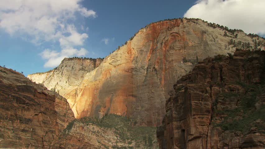 Scenic cliff face and blue sky with clouds at Zion National Park 