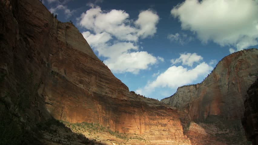 Scenic cliff face and blue sky with clouds at Zion National Park 