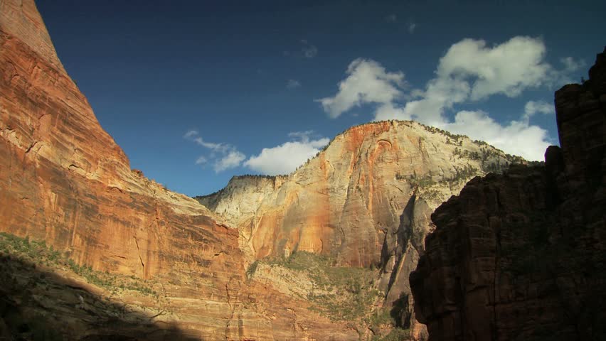 Scenic cliff face and blue sky with clouds at Zion National Park 