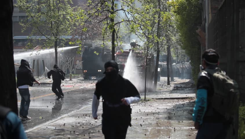 SANTIAGO, CHILE - SEPTEMBER 22: Water cannon truck disperses demonstrators during a student strike on September 22, 2011 in Santiago, Chile. Protesters demand the government to improve education quality.