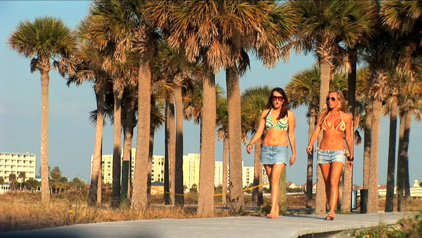 Beautiful young girls walking on the boardwalk