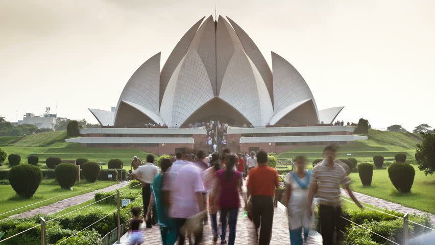 OLD DELHI, INDIA - CIRCA MAY 2011: People walking along a causeway in front of the Lotus Temple (Baha'i Temple), the Lotus Temple in Delhi is the latest of seven such temples around the world