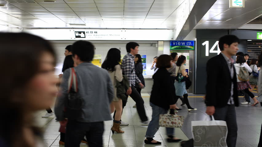 TOKYO - JUNE 11: Japanese walking through a ticket gate in Shinjuku, Tokyo on June 11, 2012. With more than 1.5 million passengers per day, Shinjuku is the biggest station in the world.
