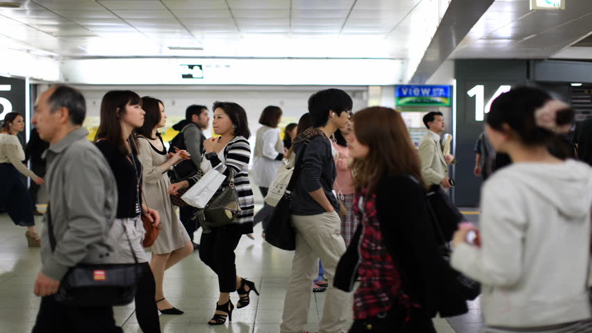 TOKYO - JUNE 11: Japanese walking through a ticket gate in Shinjuku, Tokyo on June 11, 2012. With more than 1.5 million passengers per day, Shinjuku is the biggest station in the world.