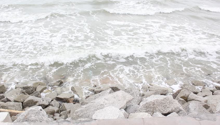 Big waves and heavy wind hit the rock beach