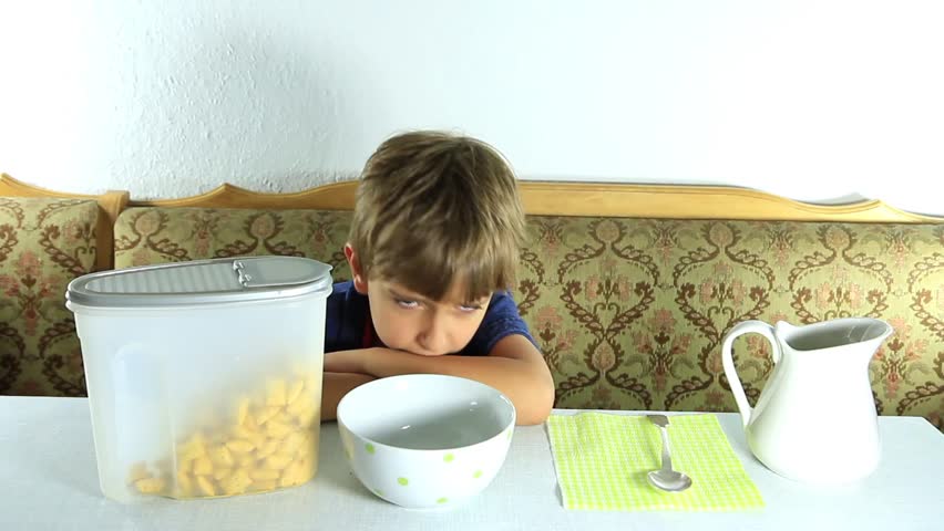 Boy eats granola with milk