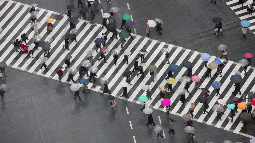 TOKYO, JAPAN - CIRCA MAY 2011: Shibuya Crossing, crowds of people crossing the famous crosswalks at the center of Shibuyas fashionable shopping and entertainment district