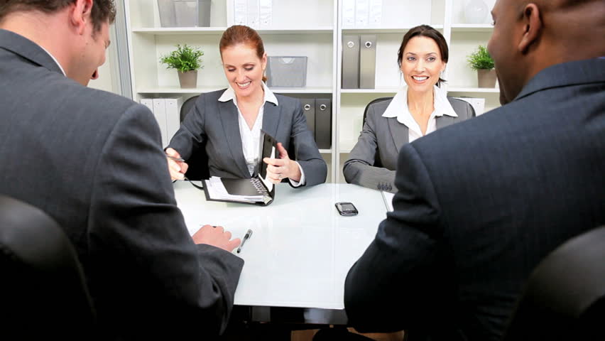 Multi ethnic legal team meeting clients modern law chambers